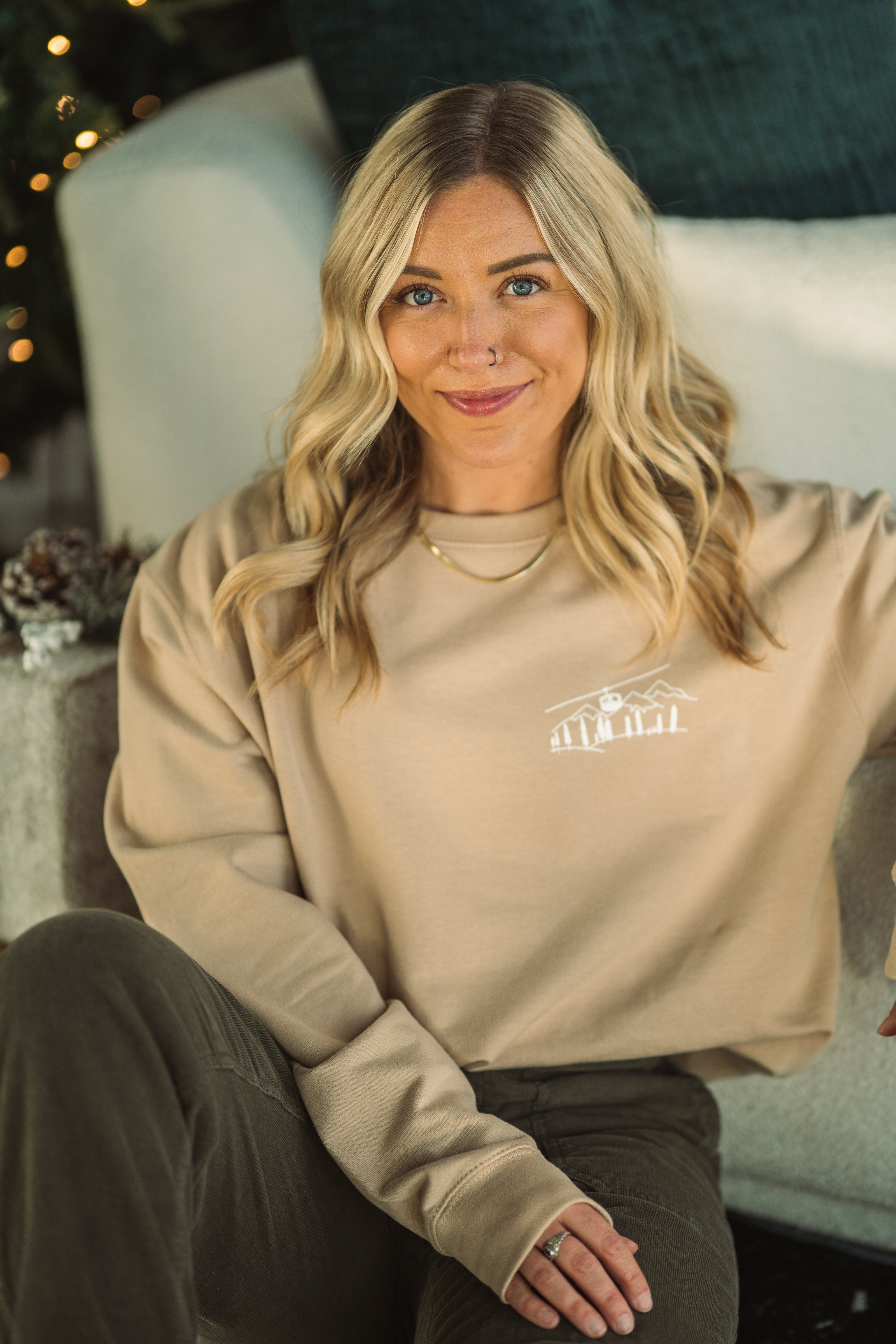 Close-up of the embroidered Alpine Inspired artwork on a crewneck sweatshirt.
