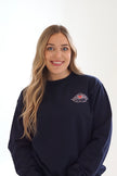 Woman wearing a black Angel Heart crewneck sweatshirt with a red heart and wing embroidered graphic on the chest.