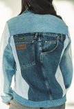 Back view of a one-of-a-kind patchwork denim jacket made from recycled jeans featuring authentic Wrangler pocket details.
