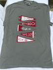 A heather gray short-sleeve t-shirt laid flat on white fabric, featuring a graphic of four red and white pennants with the words 'Columbus', 'Ohio', 'high st. GAME DAY', and 'Kick off'.