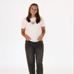 Model wearing a white Columbus Soccer boxy tee with an embroidered vintage-inspired Columbus soccer crest.