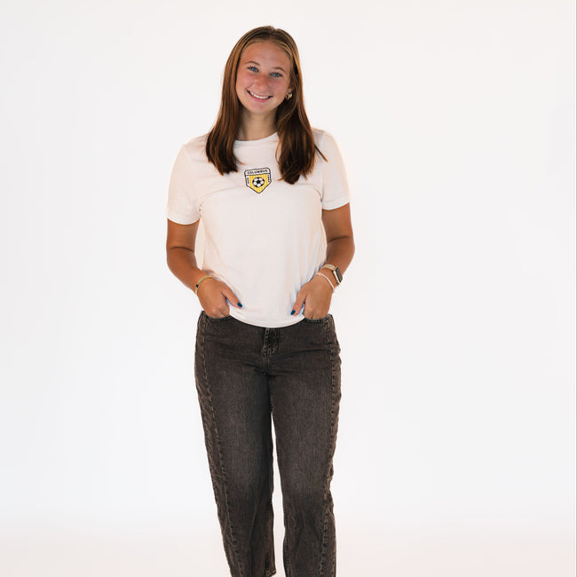 Model wearing a white Columbus Soccer boxy tee with an embroidered vintage-inspired Columbus soccer crest.