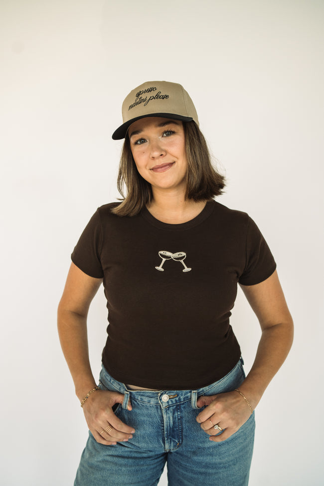 Model wearing a brown embroidered espresso martini baby tee featuring a minimalist cocktail design.