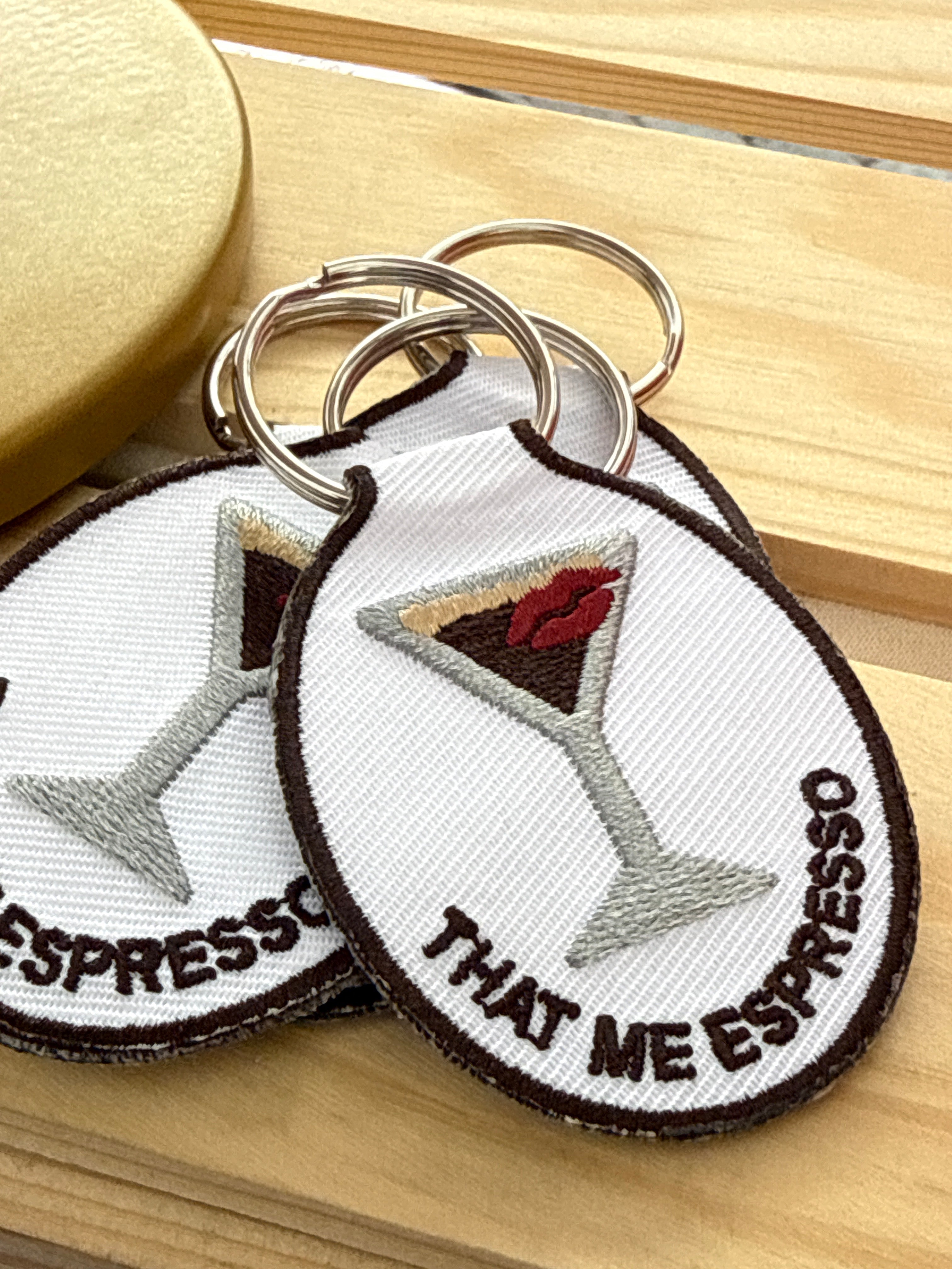 Embroidered Espresso Tini keychain featuring an espresso martini design with a gold key ring.