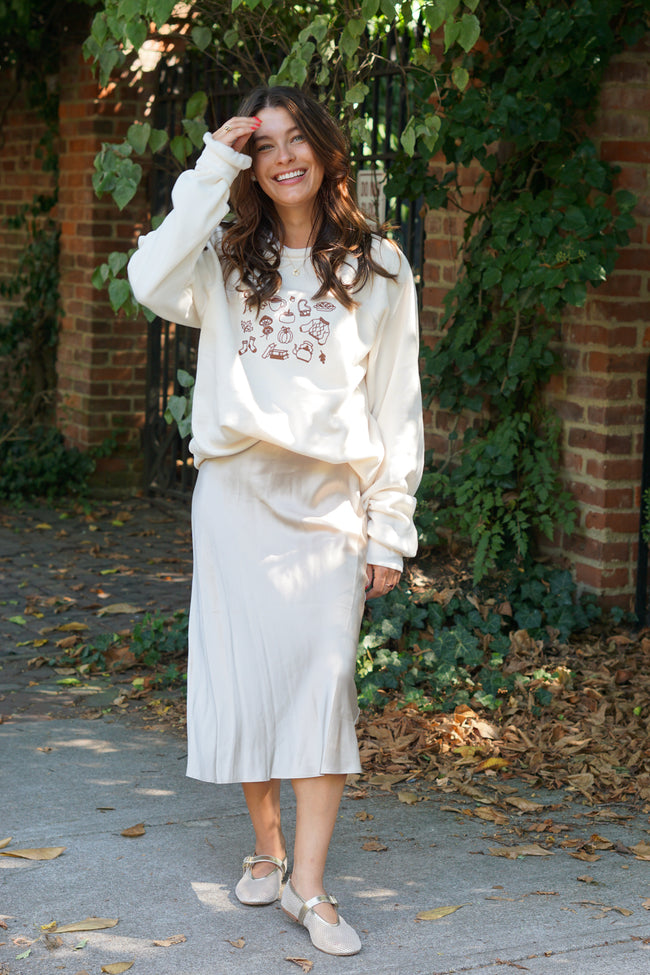 Model wearing an ivory Fall Essentials crewneck sweatshirt styled for a casual yet elevated fall outfit.