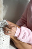 Close-up of the personalized embroidered engagement date on the sleeve of a light pink Fiancé bow crewneck sweatshirt.