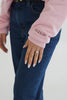 Close-up of custom wedding date embroidery on the sleeve of a personalized bridal crewneck sweatshirt.