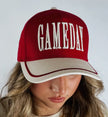 Red and white cap with 'GAMEDAY' text worn by a person