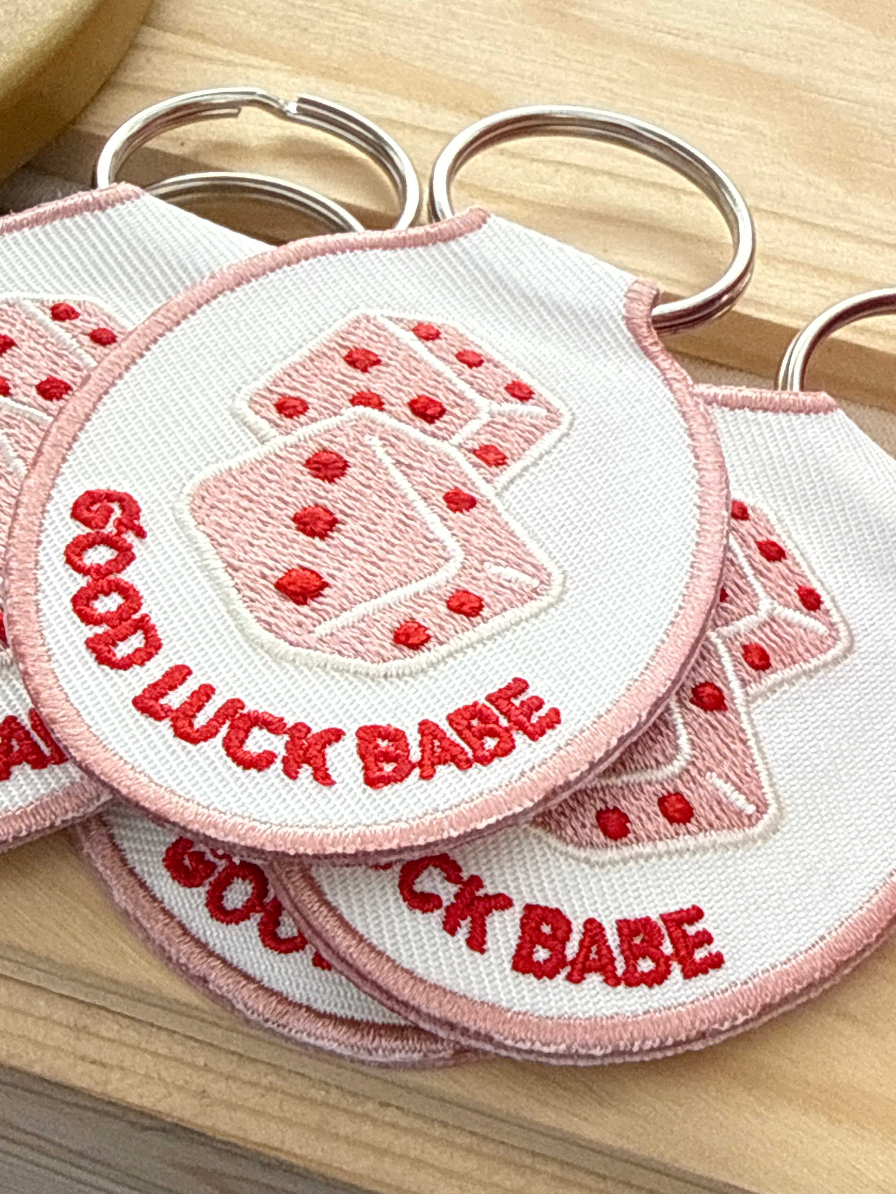 Embroidered Good Luck Babe keychain featuring a lucky dice design and gold key ring.