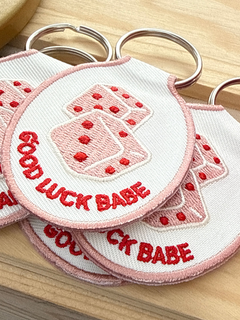 Embroidered Good Luck Babe keychain featuring a lucky dice design and gold key ring.
