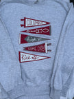 A heather gray crewneck sweatshirt featuring a graphic of five red and gray pennants with text reading 'Columbus', 'Ohio', 'high st.', 'GAME DAY', and 'Kick off'.