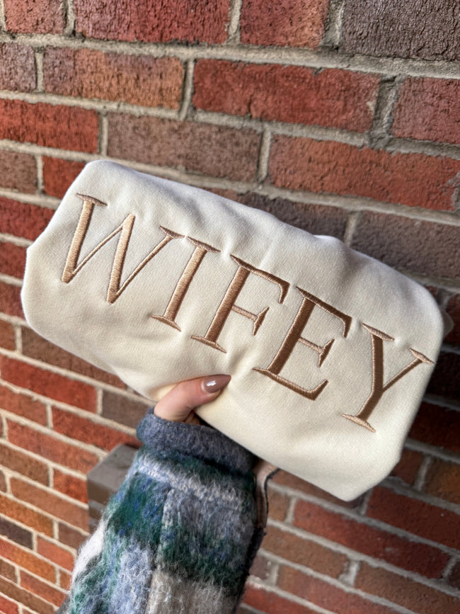 Close-up of a cream bridal sweatshirt with embroidered 