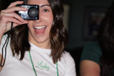 Woman wearing an ivory baby tee embroidered with green 