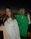 Woman wearing a cream crewneck with green embroidered “Lucky” lettering, styled for a St. Patrick’s Day celebration.