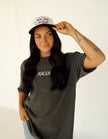 Woman wearing a slate gray Ohio Flags Comfort Colors embroidered T-shirt with a casual everyday outfit.