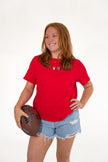 Woman wearing a red short-sleeve T-shirt with an embroidered Ohio-themed graphic on the chest.