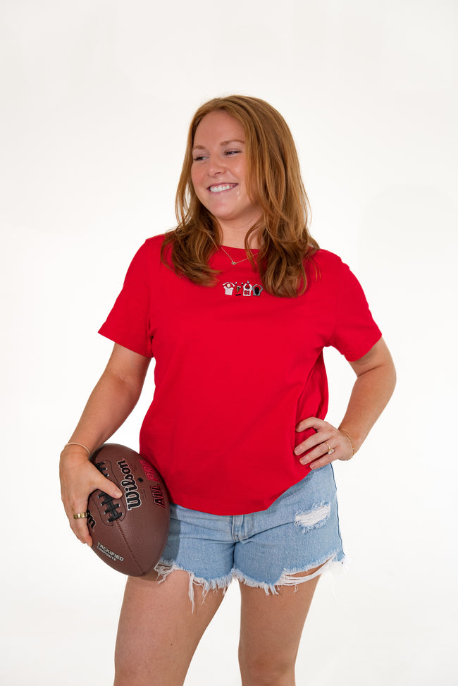 Woman wearing a red short-sleeve T-shirt with an embroidered Ohio-themed graphic on the chest.