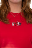 Woman wearing a red short-sleeve T-shirt with an embroidered Ohio-themed graphic on the chest.