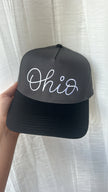 Close-up of the charcoal and black embroidered Ohio design on a structured trucker-style hat.