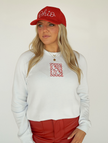 Model wearing a white embroidered Ohio stamp crewneck sweatshirt with casual denim.