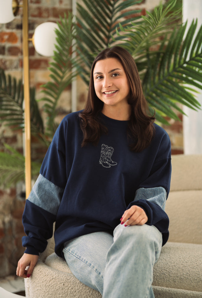 Model wearing the Western Denim Crew sweatshirt styled with casual denim.