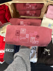 Folded red Letter to Santa crewneck sweatshirt featuring an embroidered holiday postcard design.